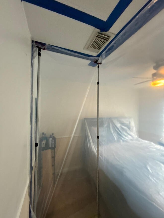 Plastic containment built inside a bedroom for mold remediation